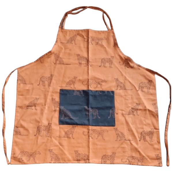 Amber-colored kitchen apron with a repeating cheetah print and a large navy blue pocket at the center front, offering a blend of functionality and playful style